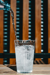 pouring the glass of ice with water