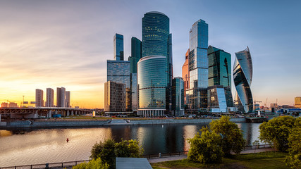 Wall Mural - Tall buildings of Moscow-City at sunset, Russia. Modern business district at Moskva River. Urban landscape at dusk.