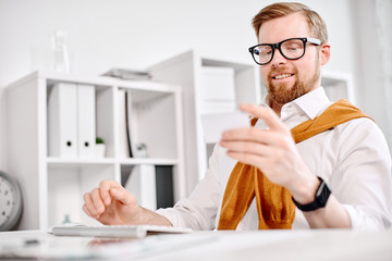 Mid age businessman working with plastic card at the computer in the office