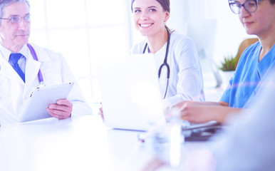 Serious medical team discussing patient's case in a bright office