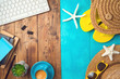 Summer holiday vacation concept with beach accessories and office desk background. Top view from above