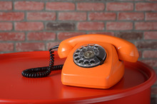 Vintage Orange Telephone On A Red Background - Close-up