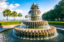 Scenic View Of Water Streaming From A Fountain In The Shape Of A Pineapple On A Blue Sky Afternoon At The Waterfront In Charleston, South Carolina, USA