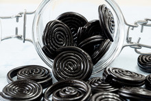 Detail Of Licorice Candy Spirals Outside A Glass Jar
