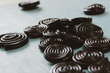 Detail of licorice candy spirals on blue background