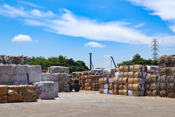 Bangkok/Thailand-June 22,2019: Thai recycle industry cardboard garbage and paper waste after pressing in hydraulic baling garbage press machine to a square dense for transportation to recycle factory