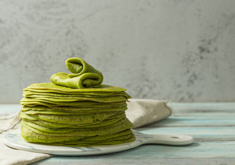 Matcha green crepes on cake board 