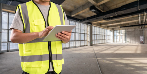 Construction Worker in front of construction site