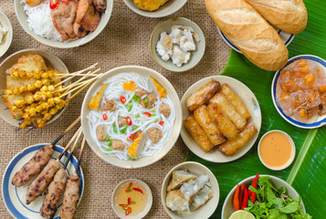 Vietnamese food background with spring roll, banh mi, banh canh, steamed fish ball, shrimp dumpling. Typical cuisine of south central of Vietnam like Binh Thuan, Ninh Thuan, Nha Trang province