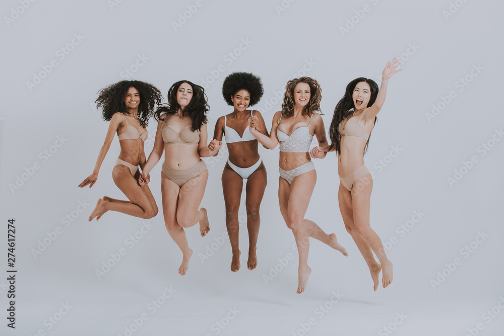 Group of women with different body and ethnicity posing together to show the woman power and strength. Curvy and skinny kind of female body concept - obrazy, fototapety, plakaty 