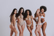 © oneinchpunch - Group of women with different body and ethnicity posing together to show the woman power and strength. Curvy and skinny kind of female body concept