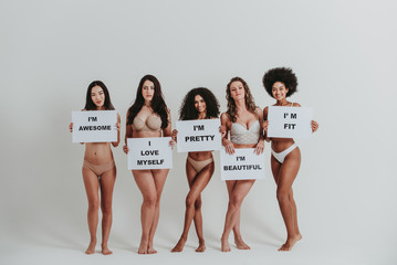 Group of women with different body and ethnicity posing together to show the woman power and strength. Curvy and skinny kind of female body concept