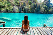 Beautiful girl relaxing at the kayangan lake. Concept about vacations and tropical places