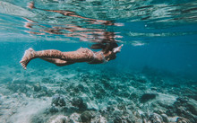 Woman Swimming Underwater. Concept About Vacations And Nature. Shot Taken With Under Water Action Camera