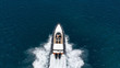 Aerial photo of inflatable rib speed boat cruising in high speed deep blue sea of Mykonos island, Cyclades, Greece