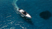 Aerial Photo Of Inflatable Rib Speed Boat Cruising In High Speed Deep Blue Sea Of Mykonos Island, Cyclades, Greece