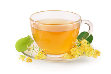 Tea from Linden flowers in glass cup with flower clusters of lime isolated on white background