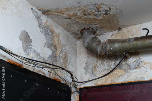 Old Water Leak On Ceiling Water Damaged Plaster And Pipe