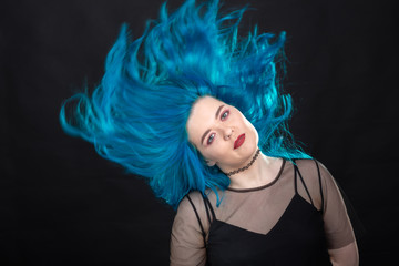 Canvas Print - Sryle and fashion concept - Close up portrait of woman with blue long hair over black background