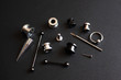 Diverse set for piercing on a dark background, ear tunnels, tunnels and earrings for the ears and tongue close-up