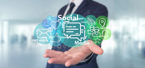Businessman holding a cloud of social media network icon