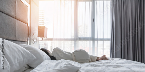 Cuadros en Lienzo Sleeping in hotel bed with good rest of young woman lifestyle lying in beroom re