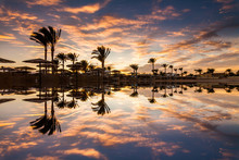 Beautiful Romantic Sunset Over A Sandy Beach And Palm Trees. Egypt. Hurghada.