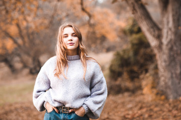 stylish teenage girl 15-16 year old wearing trendy clothes outdoors. looking at camera. 20s.