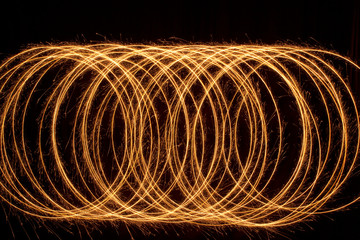 Sparkle multiple circle shape. Burning fire sparklers isolated on black.