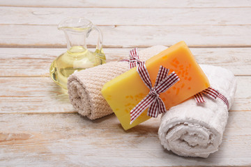 one hand-made soap and two towels and body oil with free space for text