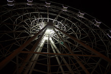 Ferris Wheel On Dark Background, Part Of Ferris Wheel With Backlight On Black Sky Background At Night