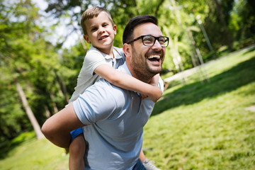 Happy father and his son spending time together and playing, smiling outdoor