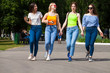 © Andrey_Arkusha - Happy women in blue jeans walking in summer park