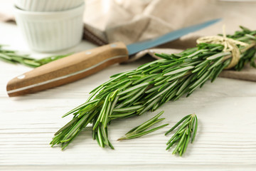 Poster - Composition with rosemary, knife, towel and sauceboats on white background