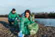 © Тарас Нагирняк - Two young students holding and gathering garbage on river bank.