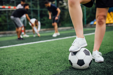 Wall Mural - Focus at soccer player with ball in action outdoors. Close up photo.