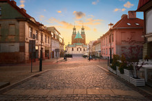 Historical Road Leading Towards Gniezno Royal Cathedral On A Sunset.
