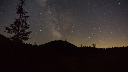 Wall Mural - purple night sky stars over mountain. milky way galaxy in summer starry night