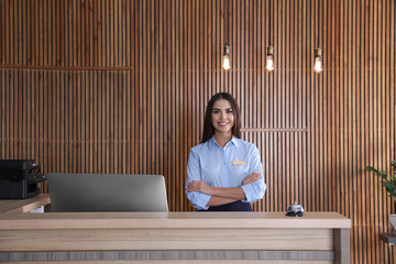 portrait of receptionist at desk in lobby