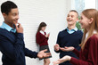© New Africa - Teenage girl preferring mobile phone to classmates at school. Concept of internet addiction and loneliness