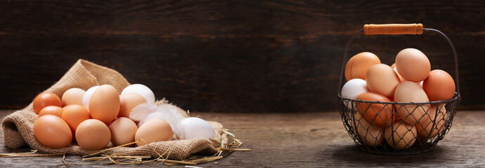 Wall Mural - basket of colorful fresh eggs on wooden table