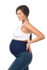 Wall Mural - Young pregnant woman wearing maternity jeans