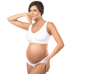 Wall Mural - Young and beautiful pregnant woman on white background