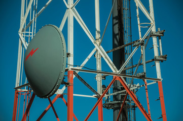 Transmission antenna dish in a tower and blue sky