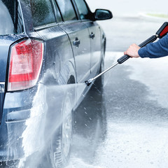 Wall Mural - Car wash worker is washing client's car