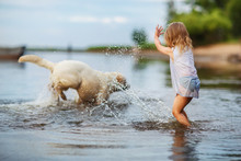Little Girl Playing With Labrador Dog, Near Lake
