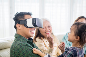 Poster - Young man wearing VR headset with his family