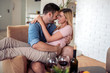 Young couple enjoying wine at home