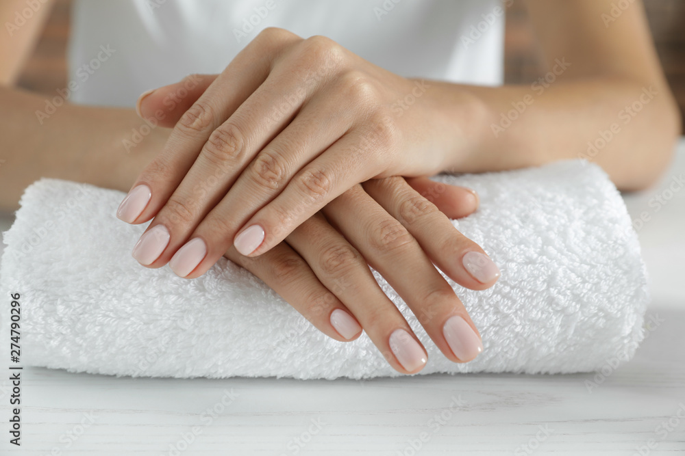 Woman showing smooth hands on towel, closeup. Spa treatment - obrazy, fototapety, plakaty 