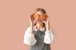 © Pixel-Shot - Happy female baker with tasty cookies on color background